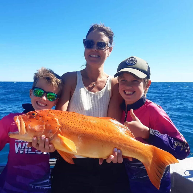 Family holding red emperor fish on Broome fishing charter