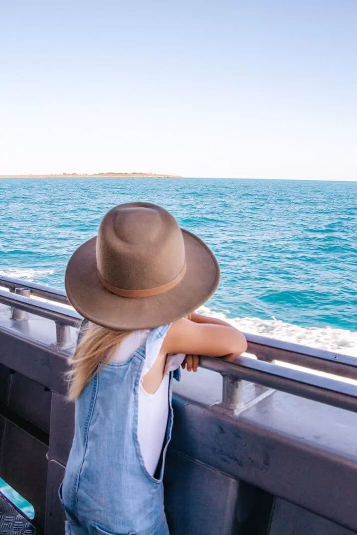 Young girl looking at ocean on Broome fishing charter