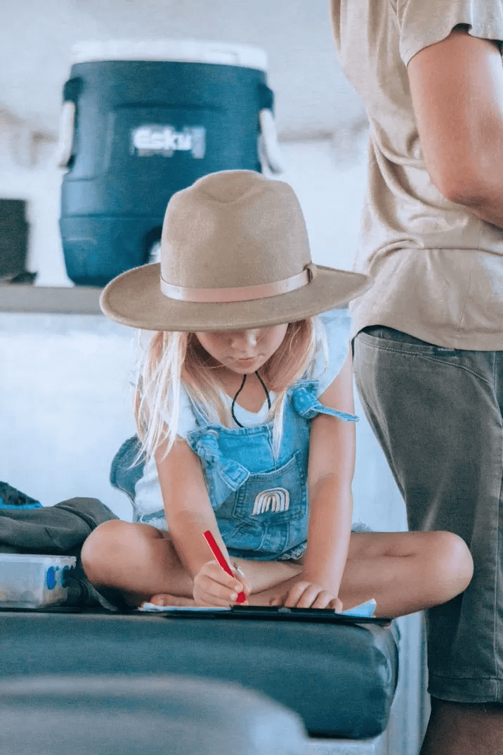 Young girl colouring in on Broome fishing charter